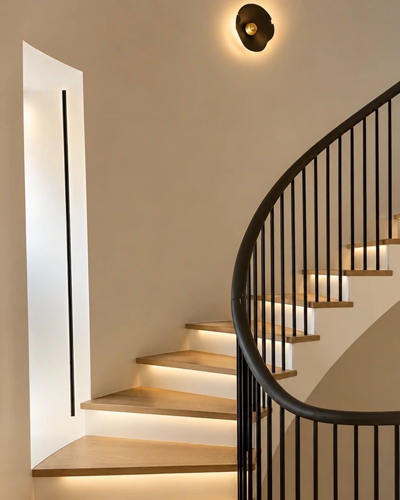 Modern winding staircase with illuminated wooden steps